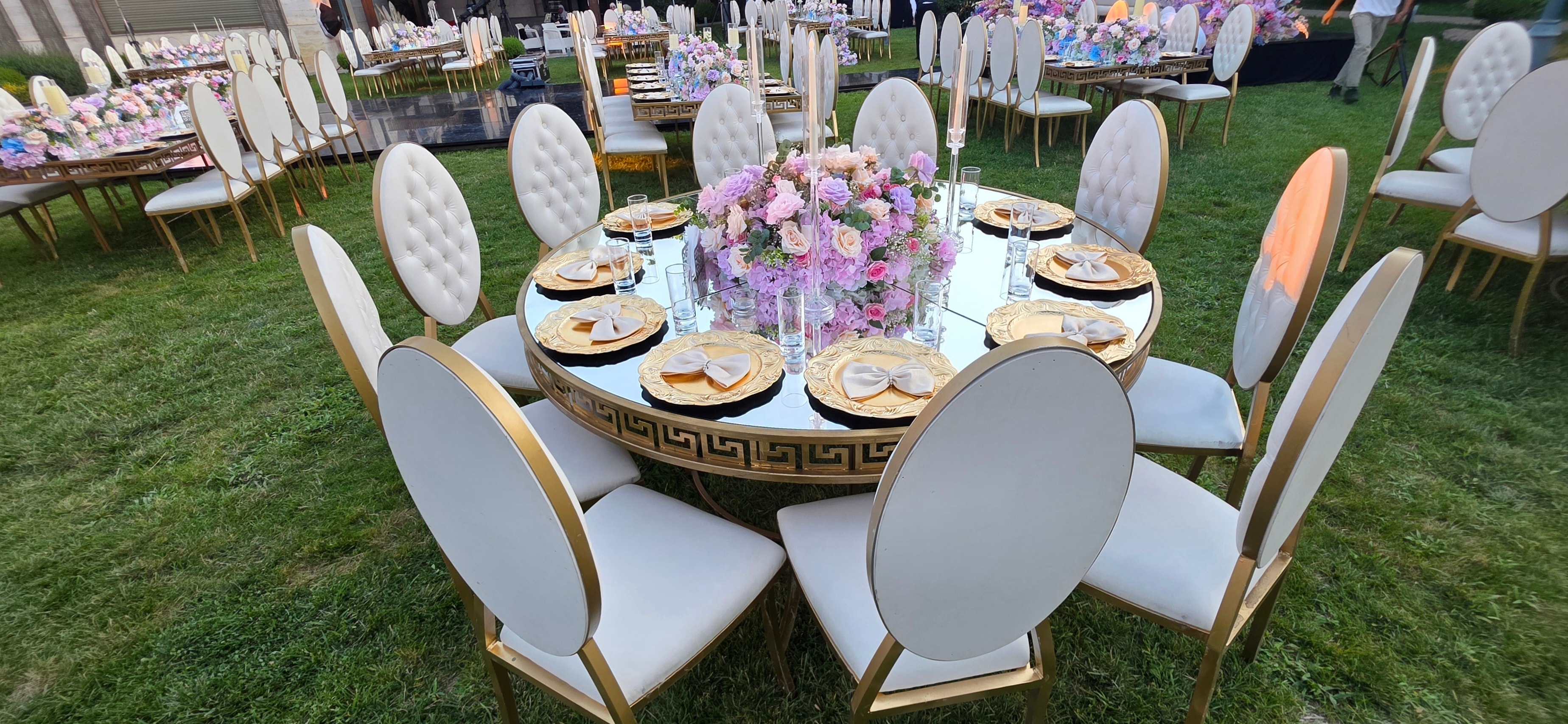 Luxurious outdoor event with floral arch and ocean backdrop